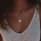 Woman wearing silver roma necklace hitting just below clavicle